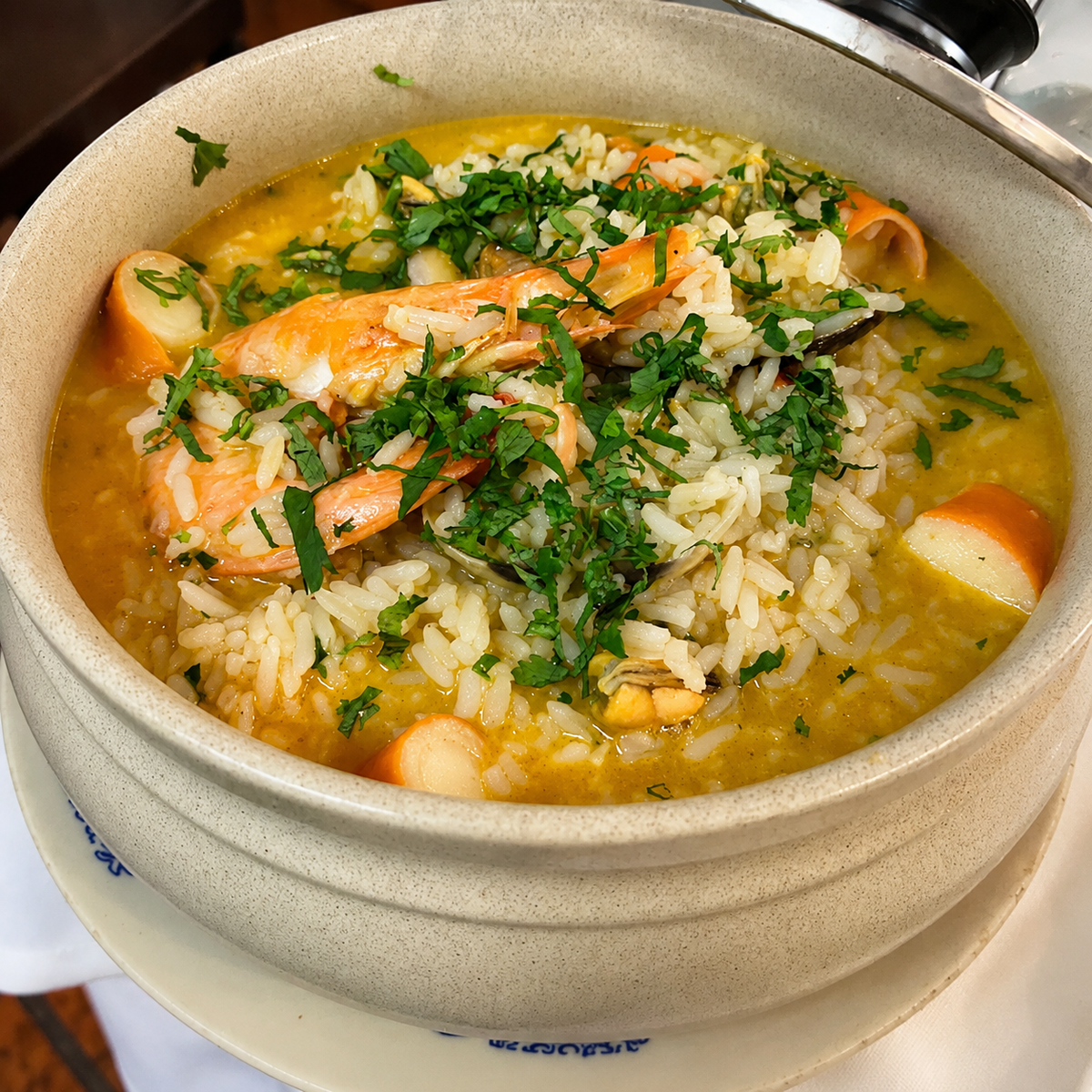 Portuguese rice with prawns served at the table